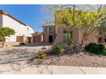 Charming stucco home featuring well-manicured desert landscaping and a private two-car garage at 42829 N Livingstone Way, Anthem, AZ 85086