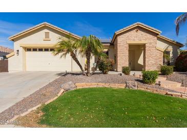 Charming single-story home featuring desert landscaping, a green lawn, and a two-car garage at 450 E Alamosa Dr, Chandler, AZ 85249