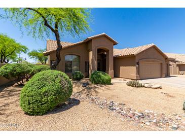 Charming home featuring desert landscaping, a tiled roof, and an arched entryway at 5009 E Baker Dr, Cave Creek, AZ 85331