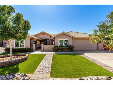 Charming home featuring desert landscaping and artificial turf for low maintenance beauty at 6543 E Preston St, Mesa, AZ 85215