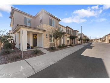 Attractive two-story home with a mix of stone and stucco exterior with a landscaped front yard at 759 E Zesta Ln # 104, Gilbert, AZ 85297