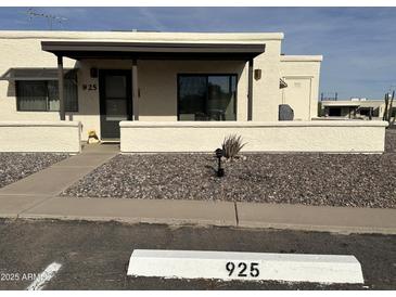 Charming single-story home featuring neutral stucco and a covered front entrance in a well-maintained community at 925 E Lancaster Cir, Florence, AZ 85132