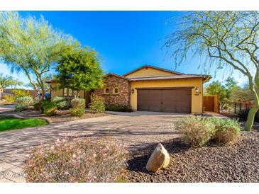 Beautiful single-story home with stone accents, desert landscaping, and a paver driveway at 12034 W Red Hawk Dr, Peoria, AZ 85383