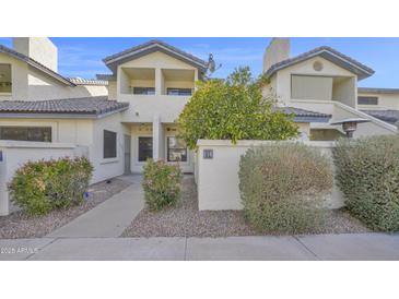 Inviting condo exterior featuring a private balcony and charming landscaping at 1222 W Baseline Rd # 114, Tempe, AZ 85283
