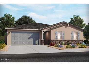 Charming single-story home with stone accents, gray shutters, and a two-car garage at 174 S 177Th Ln, Goodyear, AZ 85338