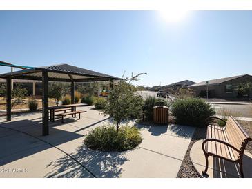 Community park with picnic tables and benches offers a relaxing outdoor space for gatherings and leisure activities at 34427 N Timberlake N Mnr, San Tan Valley, AZ 85144