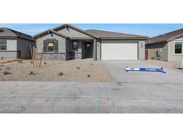 Charming single-story home featuring neutral stucco, stone accents, and a two-car garage at 34464 N Timberlake N Mnr, San Tan Valley, AZ 85144