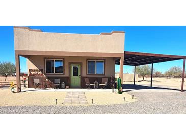 Charming home with a covered porch and carport perfect for outdoor living and entertaining at 35524 N 215Th Dr, Wittmann, AZ 85361