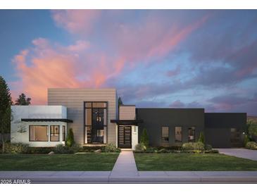 Contemporary home showcasing a striking facade, manicured lawn, and modern design elements at dusk at 86Xx E Stagecoach Pass # 4, Carefree, AZ 85377