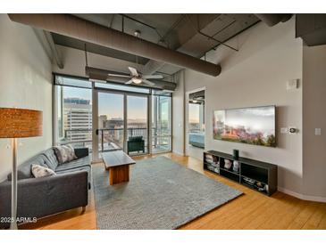 Inviting living room featuring a large window with city views and comfortable seating at 1 E Lexington Ave # 1211, Phoenix, AZ 85012