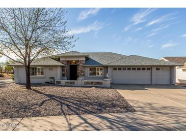 Charming single-story home features a well-kept yard and a three car garage at 11265 E Laguna Azul Cir, Mesa, AZ 85209