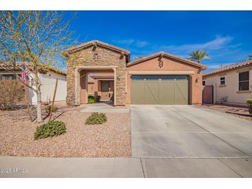 Charming single-story home with stone accents, a two-car garage, and desert landscaping at 13108 N 91St N Ln, Peoria, AZ 85381