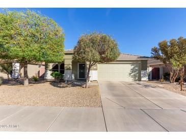 Charming single-story home with a two-car garage and mature trees at 221 N 151St Ave, Goodyear, AZ 85338