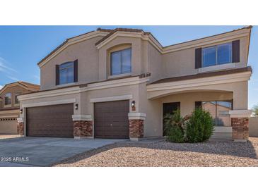 Charming two-story home featuring a three-car garage, neutral stucco, and inviting front entrance at 23407 W Ashleigh Marie Dr, Buckeye, AZ 85326