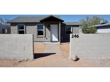 Charming exterior view of a single-story home featuring block wall and tidy landscaping at 246 E Central Ave, Coolidge, AZ 85128