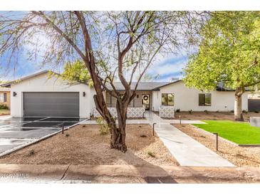 Charming home featuring xeriscaped landscaping, modern accents, and a welcoming entrance at 3033 E Roma Ave, Phoenix, AZ 85016