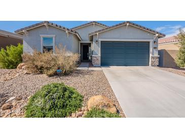 Charming single-story home with desert landscaping and a two-car garage at 34074 N Beeblossom Trl, San Tan Valley, AZ 85144