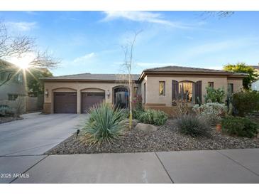 Charming single-story home boasts a three-car garage and desert landscaping for low maintenance appeal at 35322 N 27Th Ln, Phoenix, AZ 85086