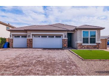 Charming single-story home featuring a three-car garage and a beautifully paved driveway at 3623 S 78Th Dr, Phoenix, AZ 85043