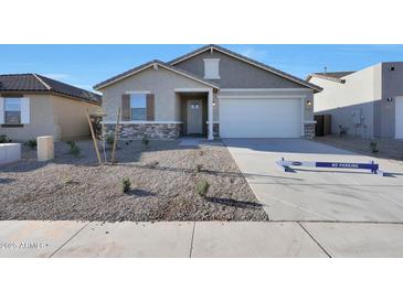 Charming single-story home featuring stone accents, a two-car garage, and desert landscaping at 4083 W Eli Dr, San Tan Valley, AZ 85144