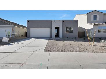 Modern home featuring a two-car garage, neutral color palette, and low-maintenance landscaping at 4093 W Eli Dr, San Tan Valley, AZ 85144