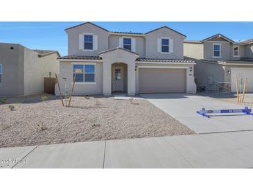 Two-story home featuring neutral colors, a two-car garage, and a low-maintenance gravel front yard at 4107 W Eli Dr, San Tan Valley, AZ 85144