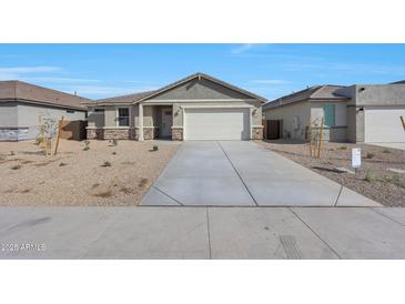 Charming single-story home featuring a two-car garage and low-maintenance desert landscaping at 4552 W Willow Run --, San Tan Valley, AZ 85144