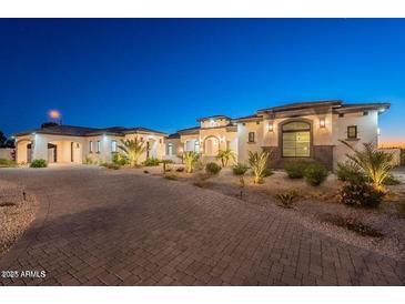 Night view of a luxury home with manicured landscaping, providing elegant curb appeal at 6378 S 154Th St, Gilbert, AZ 85298