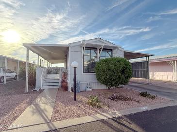 Charming single-story home featuring a covered patio, low-maintenance landscaping, and ample parking space at 652 S Ellsworth Rd # 46, Mesa, AZ 85208