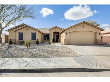 Charming single-story home with desert landscaping and a two-car garage at 7712 N 54Th Ln, Glendale, AZ 85301