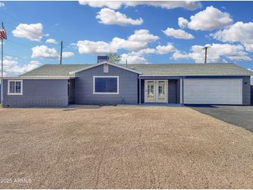 Charming single-story home with a gravel yard, white garage door, and inviting double-door entrance at 776 S Saguaro Dr, Apache Junction, AZ 85120