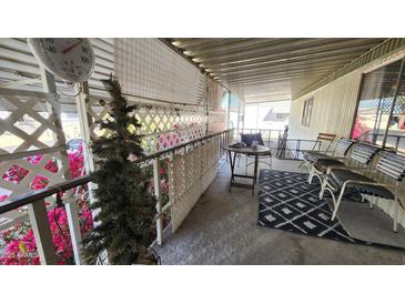 Inviting patio with cozy seating, decorative plants, and overhead cover providing a relaxing outdoor space at 11411 N 91St Ave # 48, Peoria, AZ 85345