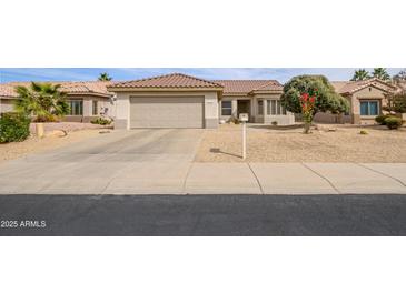 Charming single-story home featuring a desert landscape, two-car garage, and a well-maintained tile roof at 15642 W Arbor Trl, Surprise, AZ 85374