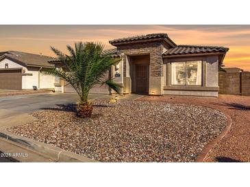 Charming single-story home featuring a desert landscape, tile roof, and cozy, welcoming entrance at 16035 N 159Th Dr, Surprise, AZ 85374