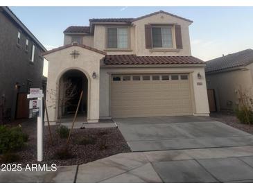 Two-story home with a two-car garage, stucco siding, and a red tile roof at 17622 W Missouri Ave, Litchfield Park, AZ 85340