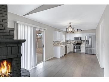 Open floor plan showcasing a modern kitchen with stainless steel appliances at 2593 E Commonwealth Cir, Chandler, AZ 85225