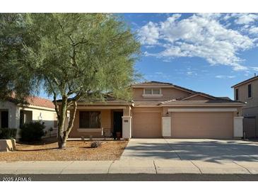 Charming single-Gathering home with desert landscaping and a two-car garage on a sunny day at 36452 W Velazquez Dr, Maricopa, AZ 85138