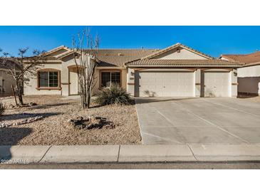 Charming single-story home featuring a three-car garage, tile roof, and low maintenance desert landscaping at 3756 E Camden Ave, San Tan Valley, AZ 85140