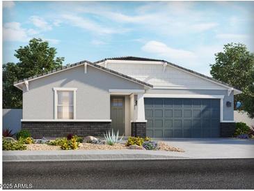 Charming single-story home with a two-car garage, desert landscaping, and neutral color palette at 3806 N Camden Dr, Florence, AZ 85132