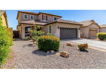Charming two-story home featuring a well-manicured, low-maintenance yard and inviting curb appeal at 3935 E Blue Spruce Ln, Gilbert, AZ 85298