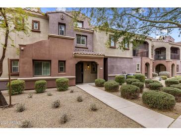 Charming townhouse featuring desert landscaping, and a covered entryway at 3935 E Rough Rider Rd # 1368, Phoenix, AZ 85050