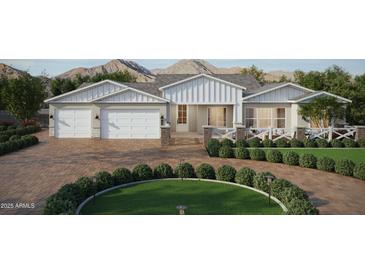 Charming home features a three-car garage and a beautifully landscaped front yard with mountain views at 9318 E Cloudview Ave, Gold Canyon, AZ 85118