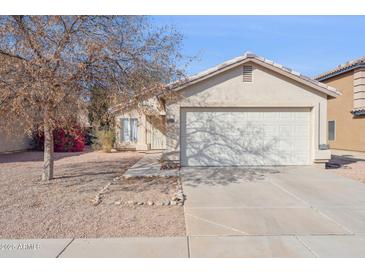 Charming single-story home with a two-car garage and low-maintenance desert landscaping at 12246 W Bloomfield Rd, El Mirage, AZ 85335