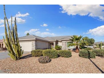 Charming single-story home with desert landscaping, stone accents, and a two-car garage at 16200 W Hearthstone Dr, Surprise, AZ 85374