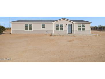 Inviting single story home with a neutral color palette, gray trim and matching entry door at 1811 N Brower Ln, Maricopa, AZ 85139