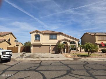 Inviting two-story home with a three-car garage and well-manicured front yard at 31487 N Blackfoot Dr, San Tan Valley, AZ 85143