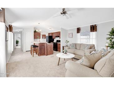 Inviting living room and kitchen featuring an open layout, comfortable seating, and modern appliances at 320 E Mckellips Rd # 227, Mesa, AZ 85201