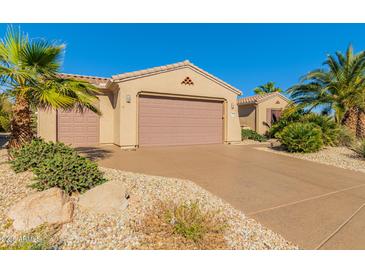 Charming single-story home featuring a two-car garage and desert landscaping at 16528 W Isleta Ct, Surprise, AZ 85387