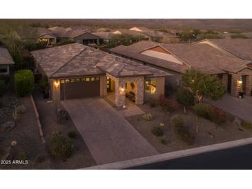 Beautiful single-story home featuring a stone facade, manicured landscaping, and a spacious two-car garage at 17670 E Fort Verde Rd, Rio Verde, AZ 85263