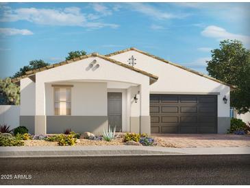 Charming single-story home with a two-car garage, desert landscaping, and a modern color palette at 17683 W Odeum Ln, Goodyear, AZ 85338